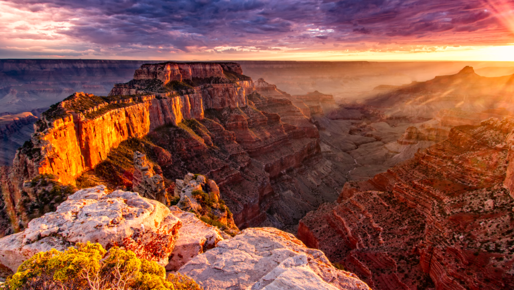 The sun is setting over the grand canyon in Arizona, offering a breathtaking view for small group tours.