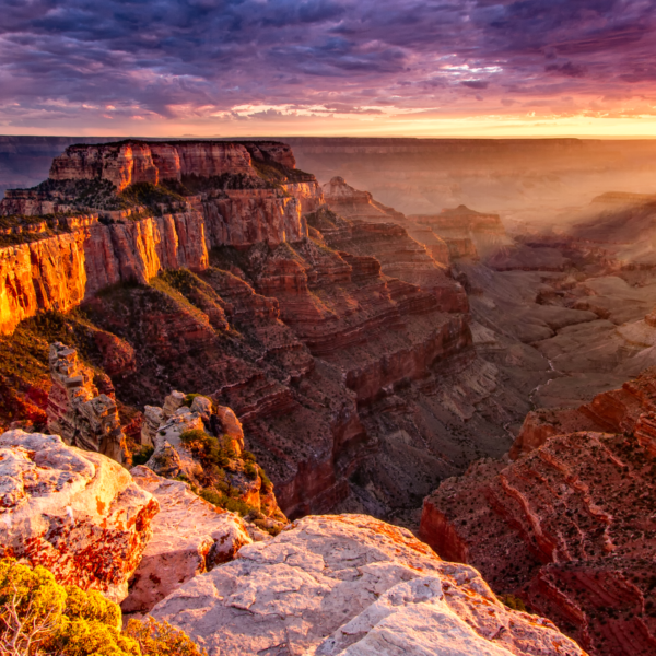 The sun is setting over the grand canyon in Arizona, offering a breathtaking view for small group tours.