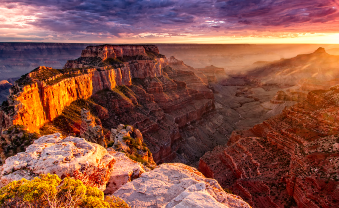 The sun is setting over the grand canyon in Arizona, offering a breathtaking view for small group tours.