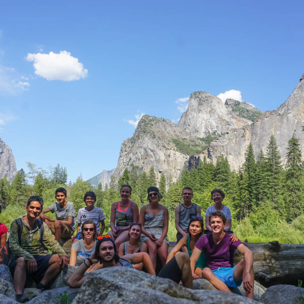 A small group of people posing for a photo in Yosemite National Park during a tour from San Francisco.