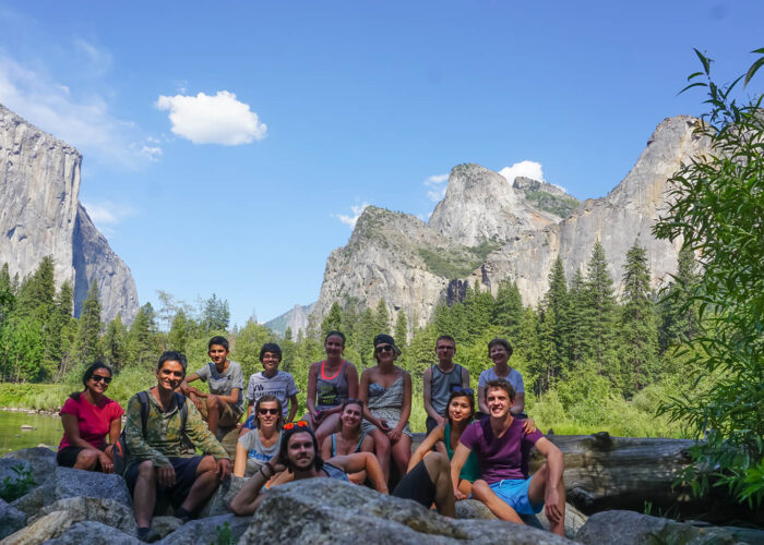 A small group of people posing for a photo in Yosemite National Park during a tour from San Francisco.