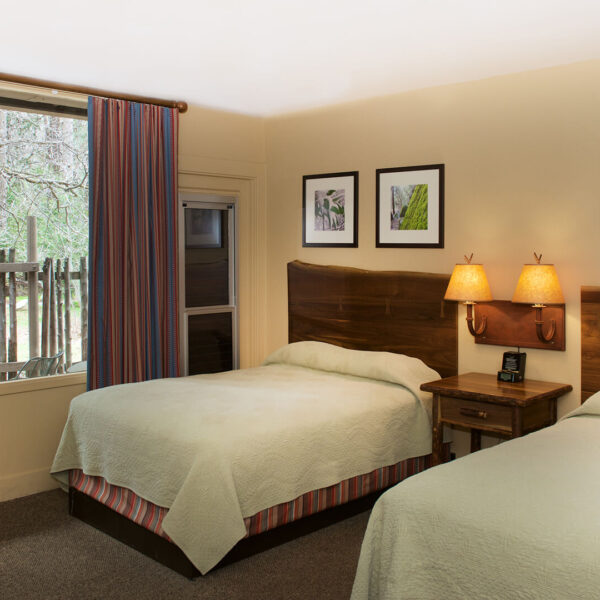 Two beds in a small group tour room in California.