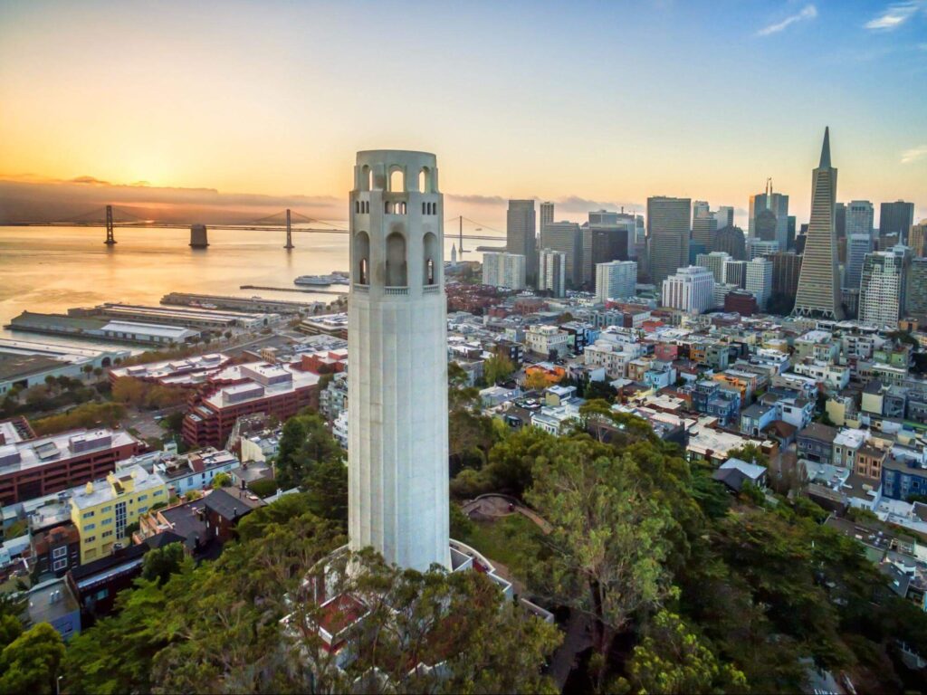 The Coit tower, an Art Deco monument in the Telegraph Hill neighborhood of San Francisco. Aerial view at sunset over the city of San Francisco.