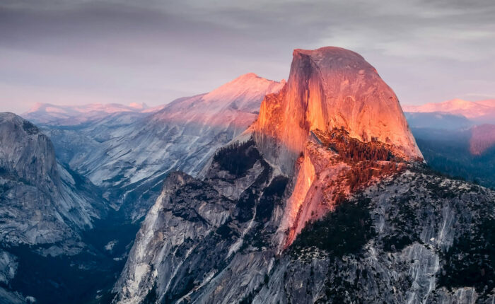 Half dome at Yosemite National Park, a breathtaking view that even non-hikers can appreciate, bathed in the warm glow of sunset.