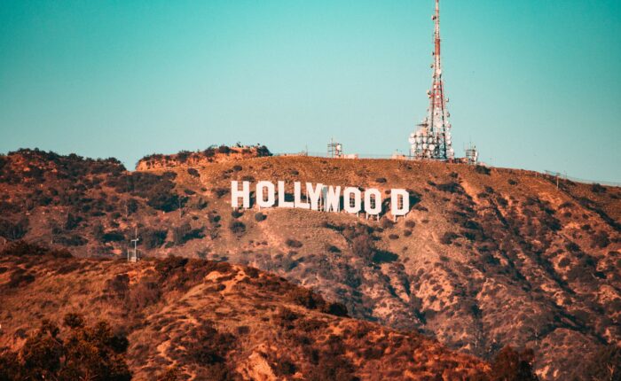 The Hollywood sign is displayed on a hillside with antenna towers in the background—an iconic sight for anyone journeying from Los Angeles to San Francisco, capturing California's allure.