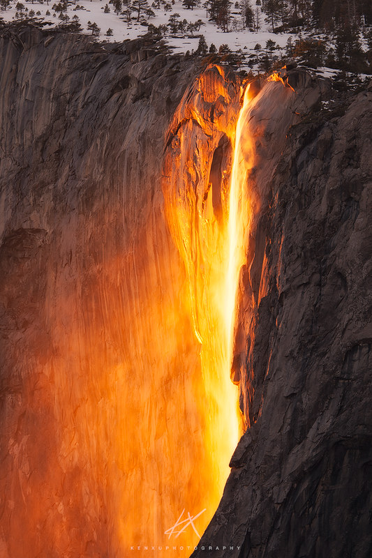 As part of the Incredible Adventures Tour in 2025, witness the Yosemite Firefall where a waterfall cascades down a rock face, bathed in bright orange sunset light for a fiery appearance, with snow delicately crowning the top.